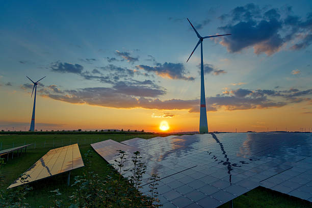 istock Solar panels and wind turbines in a scenic sunset landscape 2233204511