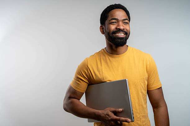 istock Handsome businessman Holding a laptop Computer 2233206754