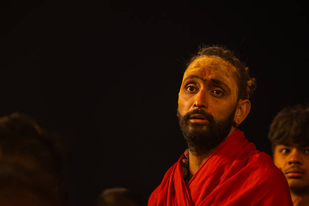 Varanasi, Uttar Pradesh, India - March 2024: Portrait of an young holy sadhu baba in traditional clothes on the ghats near ganges in varanasi.