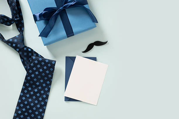 istock Greeting card with blue gift, tie on light blue background. Happy Fathers Day. 2233208977