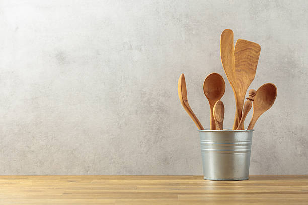 istock Wooden kitchen utensils in small bucket on a kitchen table. 2233209177