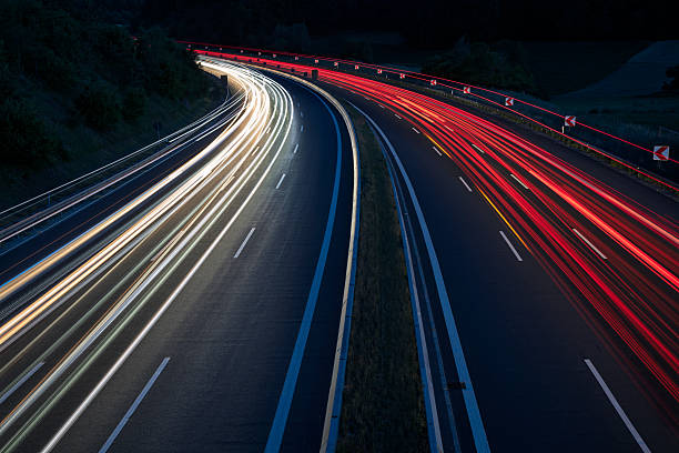 istock Car light trails on highway at night 2233212157