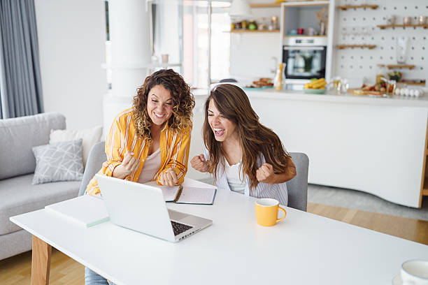istock Excited Women Working Remotely in Bright Modern Apartment with Stylish Kitchen Background 2233213618