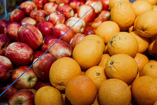 Pile of oranges and apples. The oranges are on the right and the apples are on the left