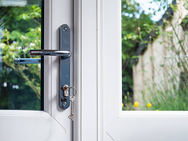 istock Key in closed door looking out onto garden 2233217859