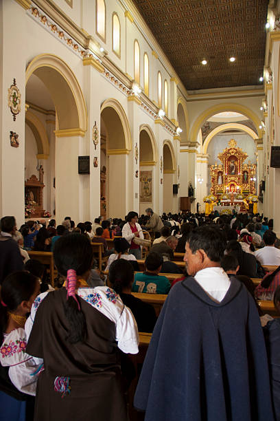 Otavalo, Ecuador - February 10, 2013: Large group of indigenous people gathering for mass in San Luis church, Otavalo, Ecuador, expressing deep devotion and celebrating rich cultural heritage through shared faith and community