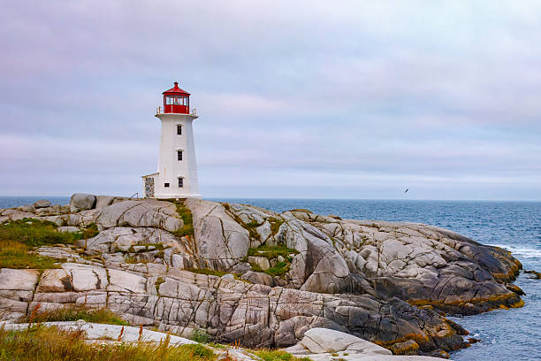 istock Peggy's Cove lighthouse at sunrise with pastel colored sky, Nova Scotia. 2233223878