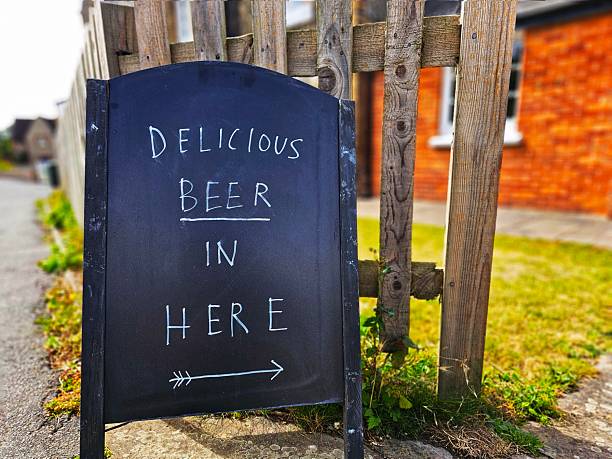 istock Delicious Beer In Here sign outside pub 2233231862