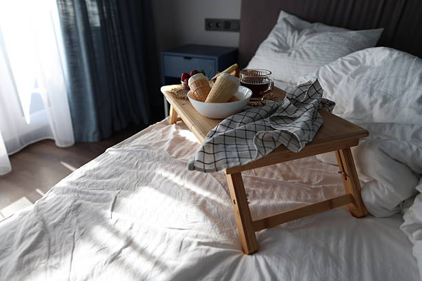 istock Cozy Breakfast in Bed With Croissants, Fruit, Cheese, Coffee, and Ice Cream Cones 2233237371