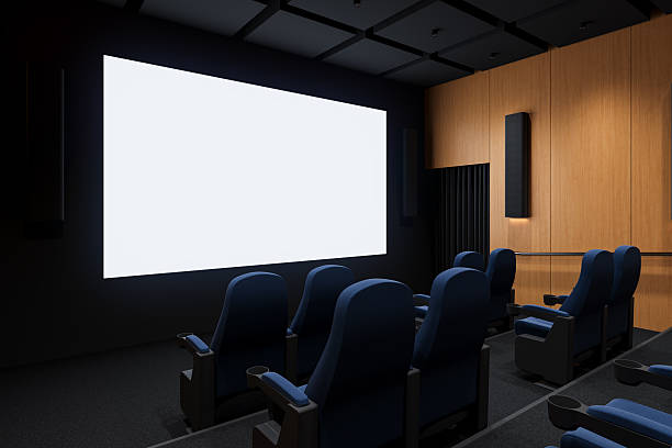 Modern home theater interior with blank white screen, blue seats, wooden panel walls and acoustic elements in dark ambiance. 3D Rendering. 3D Rendering