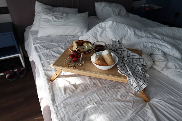 istock Cozy Breakfast in Bed With Croissants, Fruit, Cheese, Coffee, and Ice Cream Cones 2233237871