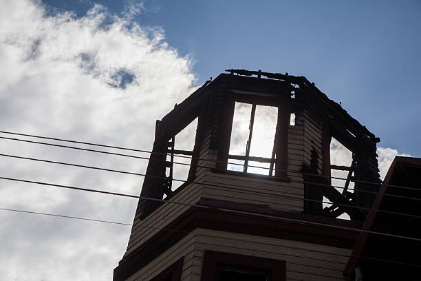 Close-up of the top floor of an old burnt wooden house back lighting