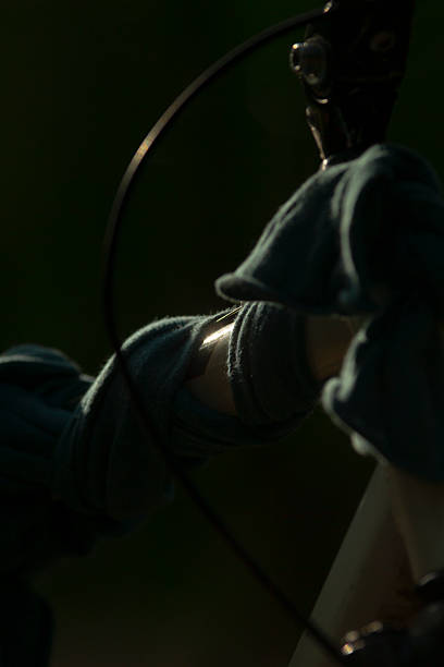 Intriguing close-up of a gloved hand gripping a tool, illuminated in low light, creating a dramatic and atmospheric effect. Perfect for themes of craftsmanship or effort.