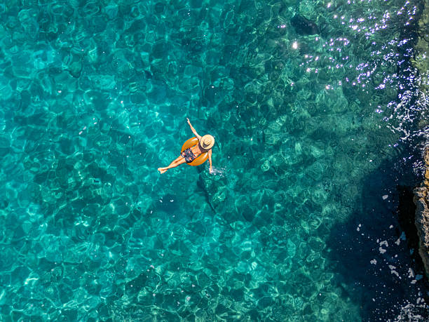 istock Man Relaxing on Float in Clear Blue Water 2233242726