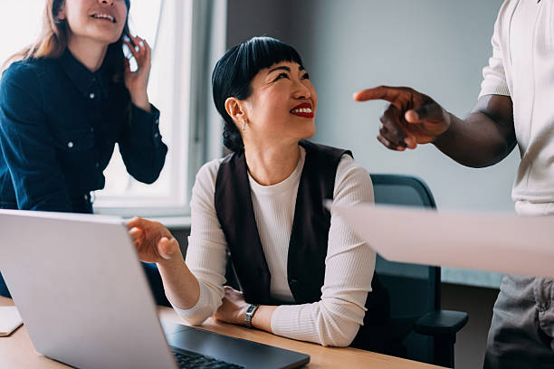 istock Colleagues Smiling and Collaborating During a Productive Team Meeting in a Bright Office 2233243016