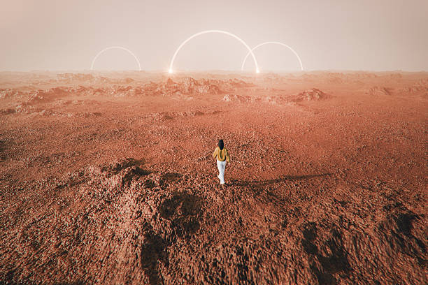 istock Woman standing in surreal rocky landscape 2233243654