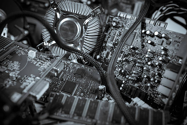 Close-up of a computer interior showcasing electronic components, including the motherboard and processing units. Emphasis on technological design, computing, and circuit complexity.