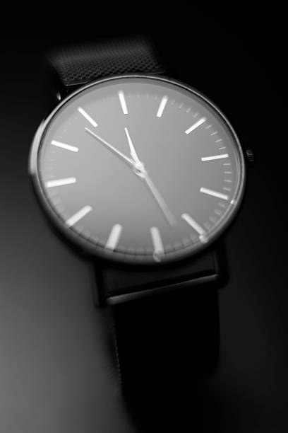 istock Elegant black and white watch on a dark background, close-up view 2233246494