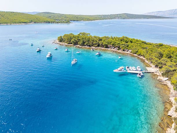istock Boats Anchored Near Small Forested Island 2233248074