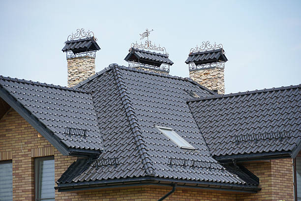 istock Elegant rooftop architecture featuring three ornate chimneys and a sloped design in a modern residential setting 2233248114