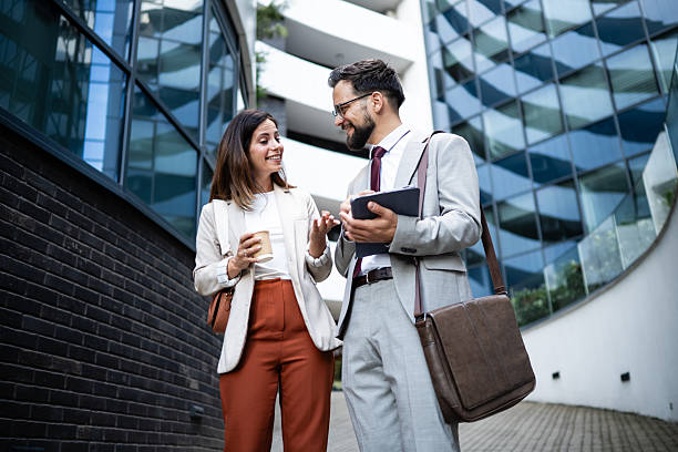 istock Business partners walking and talking in front of modern office building 2233249545