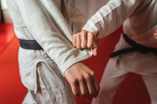 istock Two martial arts athletes practicing arm lock on tatami mat 2233249865