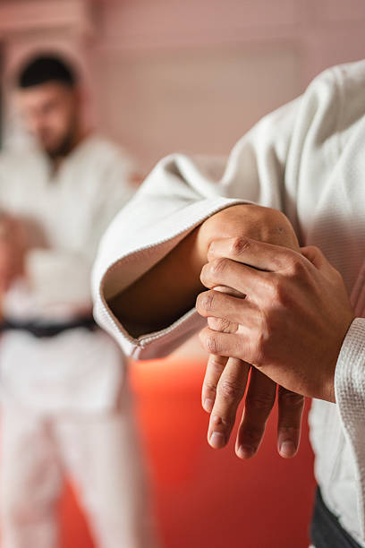 istock Martial arts athlete performing wrist lock technique during training 2233250271