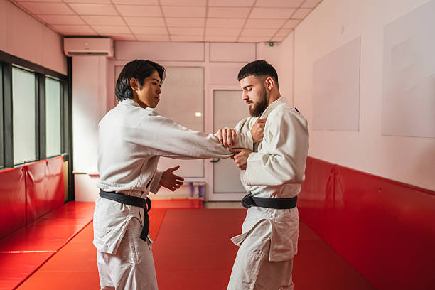 istock Two martial arts athletes practicing arm lock in gym 2233250547