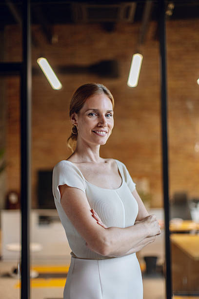 istock Confident Businesswoman Posing in Modern Office Interior With Natural Lighting 2233252461