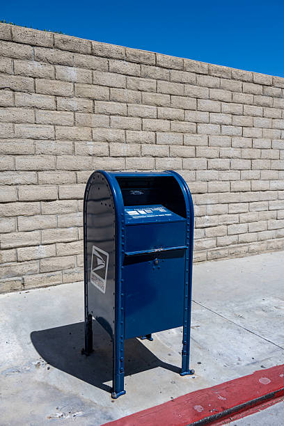Two iconic us mailboxes stand proudly on a sunny new york city sidewalk, exuding tradition and history