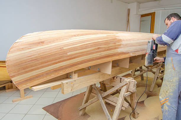 istock Carpenter making canoe of his own design 2233254447