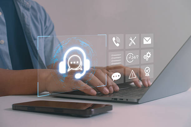 istock Customer support concept with digital headset and chatbot icons on laptop screen, symbolizing online helpdesk, virtual assistance, 24/7 service, communication technology and business support. 2233255301