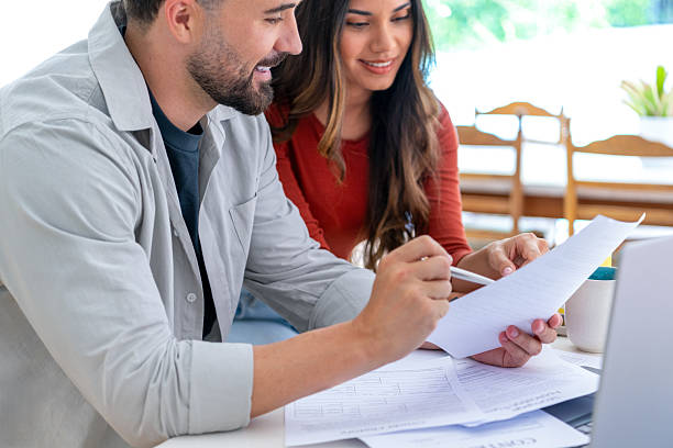 istock Young couple doing paperwork  and finances at home in the kitchen. 2233255560