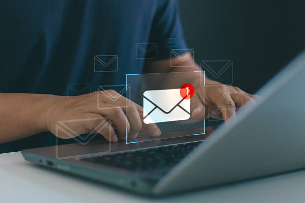 istock Businessman using laptop to check new email notification. Concept of digital communication, online messaging, marketing, customer support, customer service and modern workplace technology efficiency. 2233255767