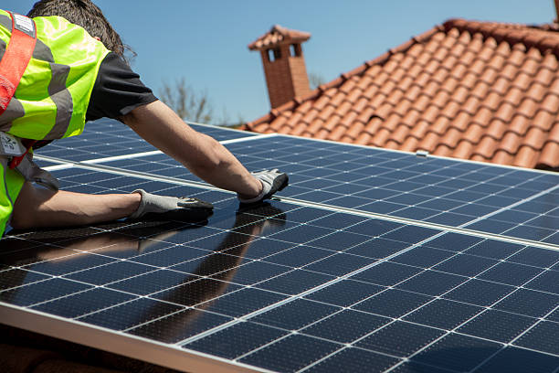 istock A skilled worker is focused on installing solar panels on a rooftop during a sunny day. The clear blue sky enhances the vibrant scene of renewable energy work. 2233257477
