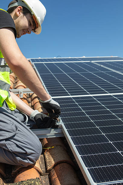 istock A skilled worker is focused on installing solar panels on a rooftop during a sunny day. The clear blue sky enhances the vibrant scene of renewable energy work. 2233257485