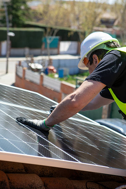 istock Solar panel installation at a residential rooftop under clear blue sky during midday 2233257519