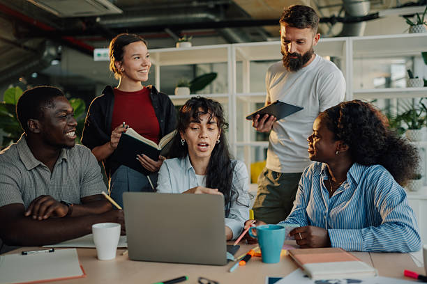 istock Diverse business team collaborating on a project using laptop in modern office 2233257650