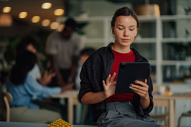 istock Young businesswoman using digital tablet in modern office 2233257706