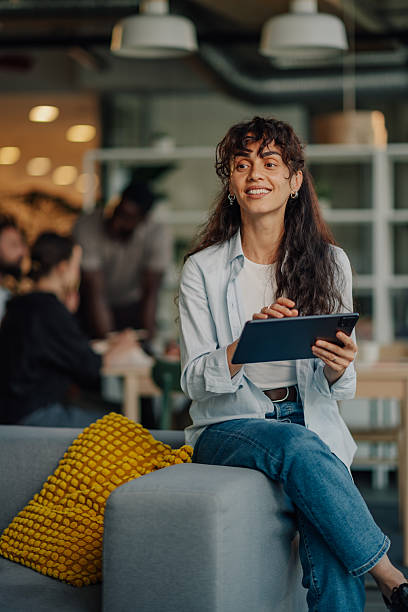 istock Smiling businesswoman using digital tablet in modern office 2233257734