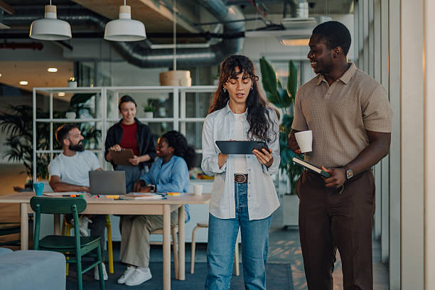 istock Business colleagues walking and talking in modern office 2233257758