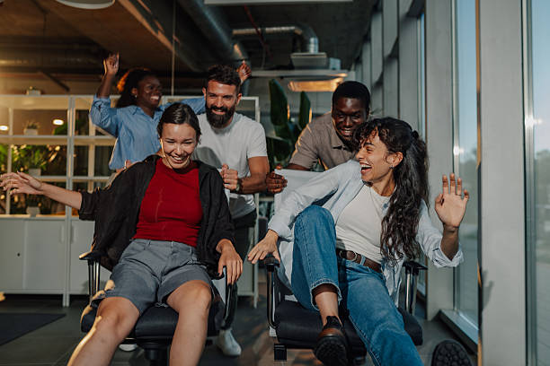 istock Cheerful business team having fun on office chairs 2233257795
