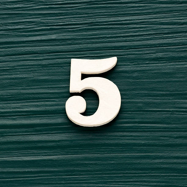 Number 5 white piece on a rustic dark green background