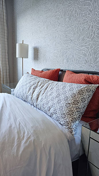istock Cozy bedroom interior featuring plush bedding, decorative pillows, and elegant lamp, creating a serene and inviting atmosphere for relaxation 2233260445