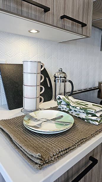 Modern kitchen countertop featuring elegant tableware, stylish mugs, and a French press, creating a cozy and inviting dining atmosphere