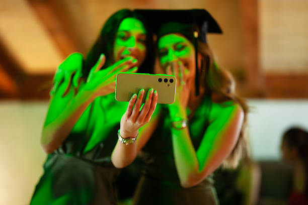 istock Two women taking a selfie during a festive graduation celebration 2233261830