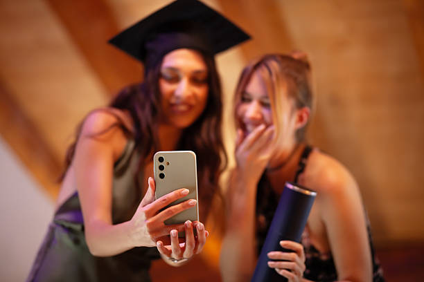 istock Young graduates celebrate achievement with a graduation selfie 2233261861