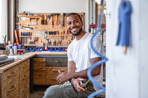 istock Professional Mid-Adult Carpenter Smiling In Well-Equipped Workshop With Natural Light 2233262420