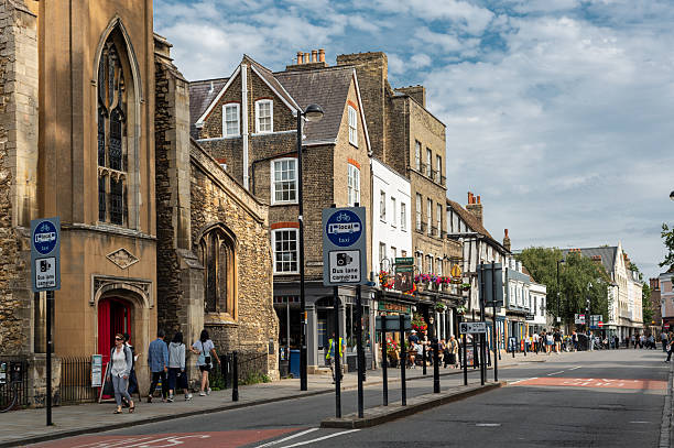 Cambridge, Cambridgeshire, United Kingdom - 07 August, 2025: City centre streets near Johns College, bikes, cafe, shops, students and tourists walking
