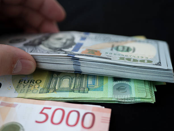 istock Stack of Euro and US Dollar Banknotes on Black Background 2233262630